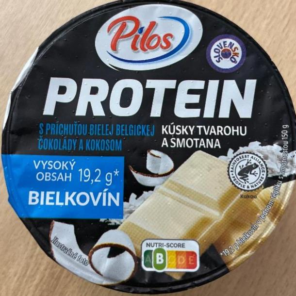 Fotografie - Protein s príchuťou bielej belgickej čokolády a kokosom kúsky tvarohu a smotana Pilos